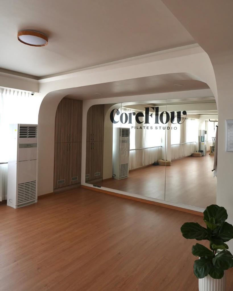 CoreFlow Pilates Studio — mirror logo and arched interior